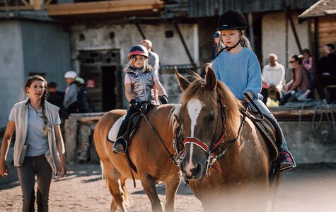 Kinder beim Reitunterricht am Reitplatz